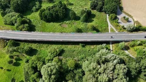 Aerial tracking shots of cars on rural suburb highway in American countryside. Bright sunny day in U