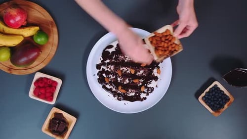 Decorating Frosted Cake with Almonds and Chocolate
