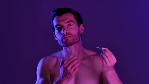 Man Applies Facial Serum With Dropper
