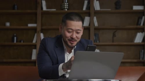 Man on Conference Video Call in Office Using Smartphone