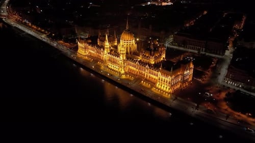 Aerial view of the Hungarian Parliament Building with the Danube river at night in Budapest, Hungary