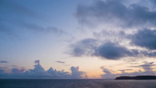 Clouds over ocean at sunset colourful time lapse
