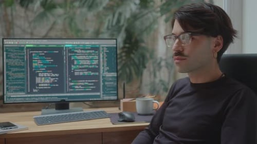 Portrait of Handsome Computer Programmer at Workplace