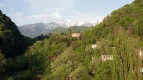 Abandoned Buildings in Picturesque Mountainous Area Covered with Greenery