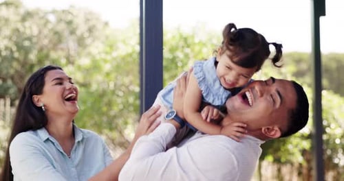 Happy, love and parents playing with their baby in the backyard garden of their family home
