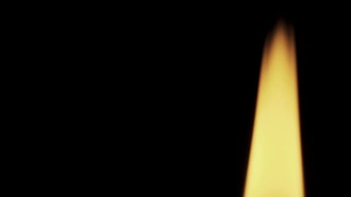 Red candle on a black background, in motion, slider shot, extinguish a candle, smoke from a candle,