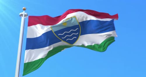 Realistic Waving Flag with Custom Emblem Against Blue Sky