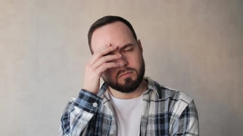 Man With Headache Holding Forehead Indoors