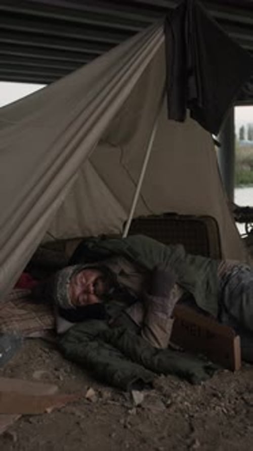 Homeless Man Sleeping Rough Near Makeshift Tent