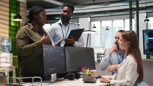 Software Team Collaborating on Code in Modern Office