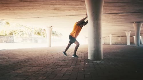 Black man, stretching against wall for workout outdoor and body health, warm up for run