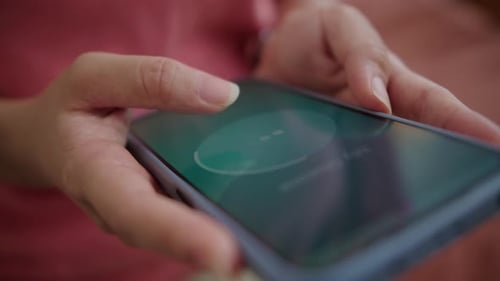 Hands of Person Unlocking Screen and Playing Video on Smartphone