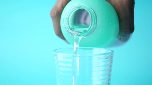 Water Pouring From a Green Color Bottle