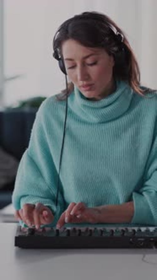 Woman Plays Electronic Keyboard Wearing Headphones