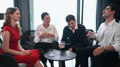 Diverse professionals in an informal business discussion or client meeting at restaurant.
