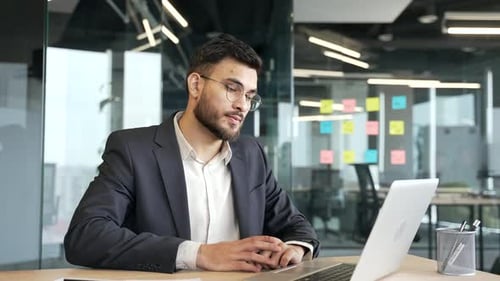 Relaxing Young Professional Taking Break at Desk