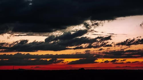 Timelapse of Clouds After Sunset Moving in the Orange Colorful Sky