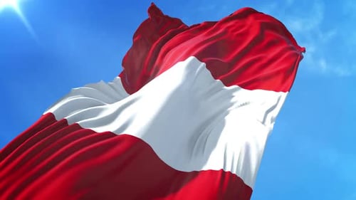 Waving Austrian Flag Against Blue Sky