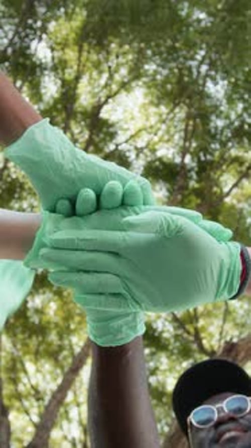 Below View of Volunteers Clasping Hands Together at Community Event