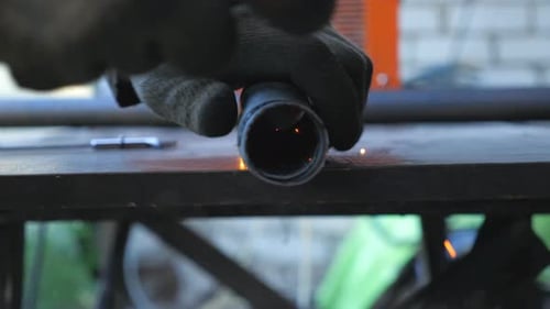 Detail View on Metal Processing with Circular Saw and Sparks Flying Around