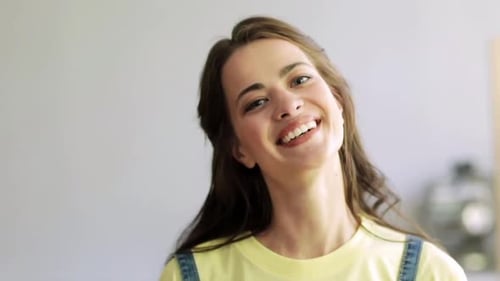 Smiling Woman Posing in Studio with Yellow Shirt