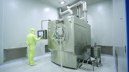 Technician Operating Pharmaceutical Manufacturing Machine in Sterile Environment
