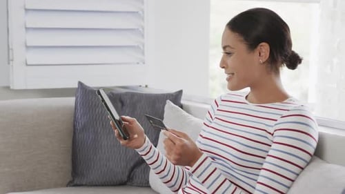 Woman With Phone and Credit Card on Couch