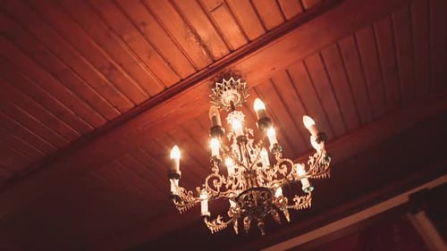 beautiful chandelier in the wooden ceiling of an old castle