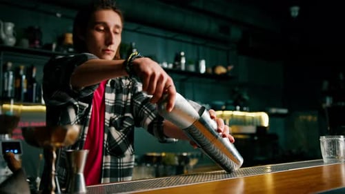 Young Adult Man Prepares Cocktail in Bar
