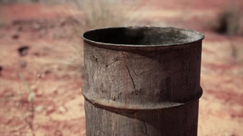 Old Empty Rusted Barrel on Sand
