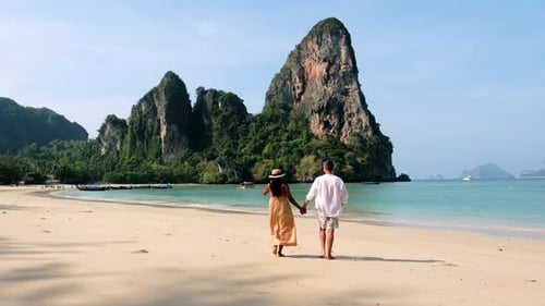 Strolling Hand in Hand on the Serene Shores of Railay Beach in Krabi Thailand