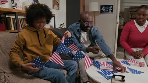 Family Making American Flag Decorations at Home