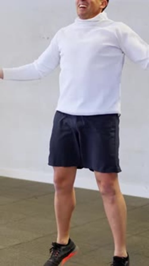 Athletic Man Doing Jumping Jacks in Slow Motion