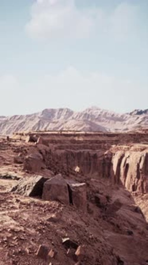 Arid Desert Landscape With Distant Mountains