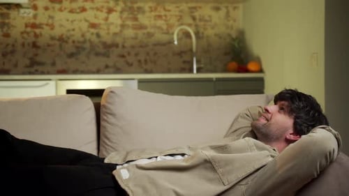 Man Relaxing on Sofa at Home