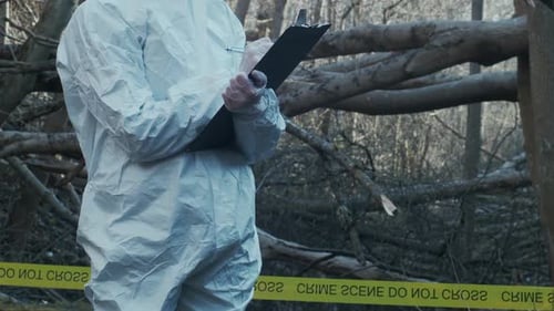 Forensic Specialist Working in the Forest Police Criminalists Collecting Evidence and Making