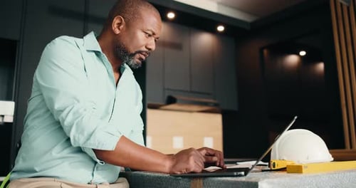 Architect, laptop and black man with documents for building plan, safety or security maintenance