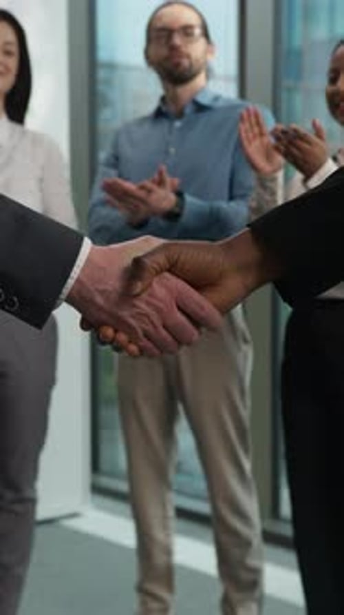Diverse Team Congratulates Handshake in Office
