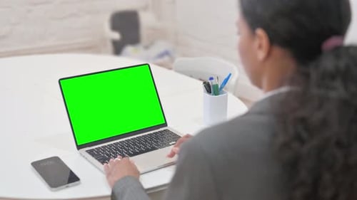 Rare View of African Business Woman Using Laptop with Green Screen