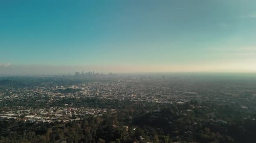 Wide Aerial Footage Over Hills and Mountains and View of Los Angeles California on Sunny Day Time