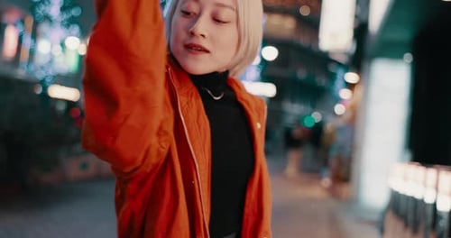Fashion, dance and woman in city at night on street in trendy clothes, cool outfit and stylish