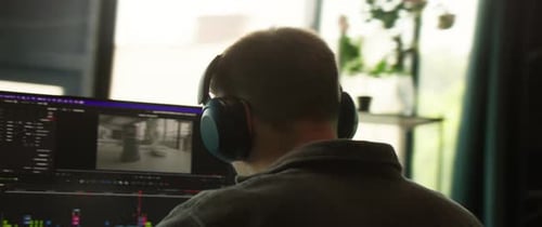 A Dedicated and Focused Professional Engaged in Work at a Computer Desk in an Office Environment