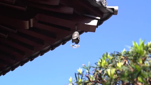 The iron bell hanging top roof in a Chinese temple, ringing by wind