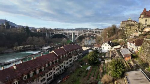Timelapse of picturesque riverside area below arch bridge in Bern city.
