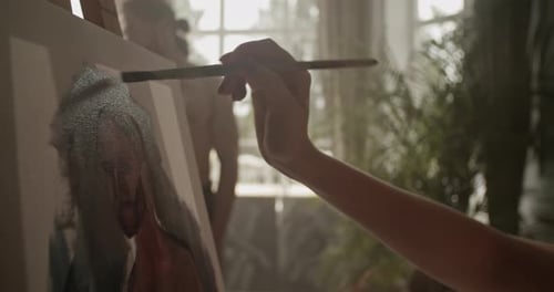 Artist Painting an Abstract Portrait in a Home Studio