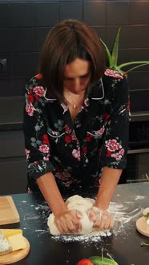 Woman Kneading Dough in Kitchen at Home