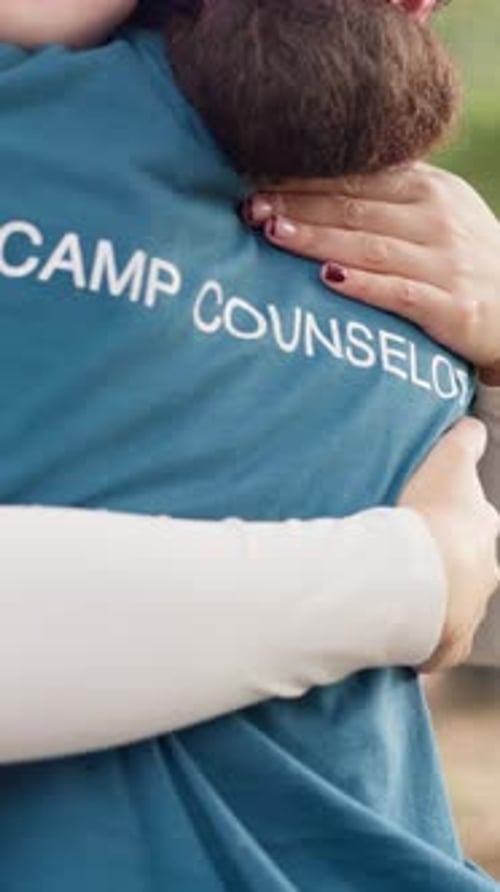 Camp counselor, hands and people with hug outdoor for safety, mentorship and conflict resolution