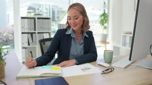 Woman Writing in Notebook at Bright Office Desk