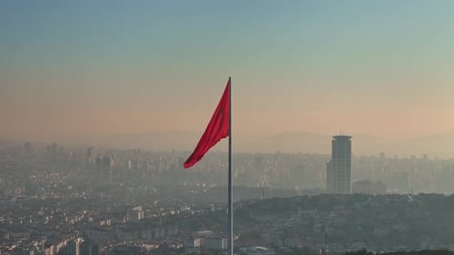 Cityscape View with Red Flag Waving