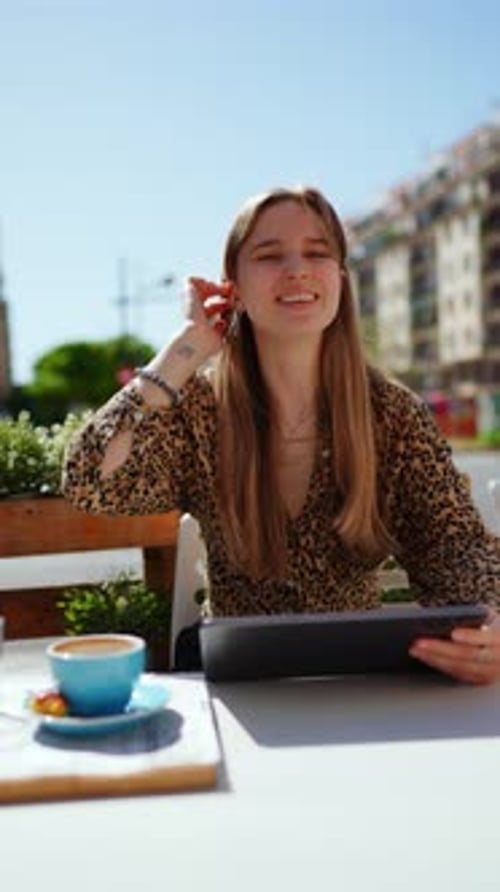 Blonde Woman Drinking Coffee Working on Digital Tablet at Sunny Outdoor City Cafe Urban Summer Light